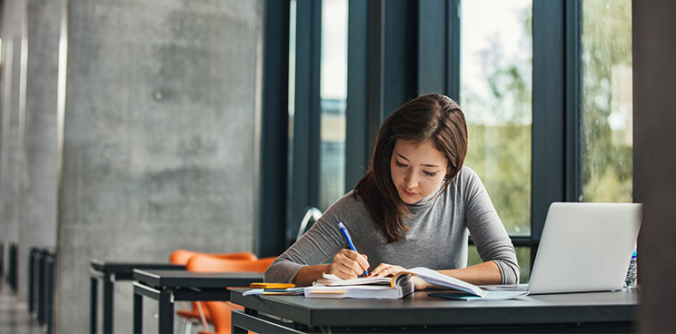 A young woman taking notes 