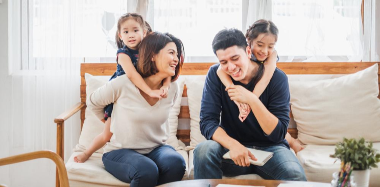 A young family having fun in the kitchen