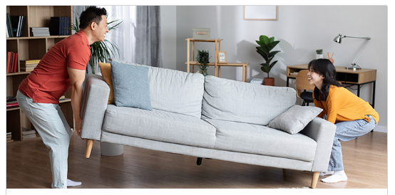 A couple moving furniture
